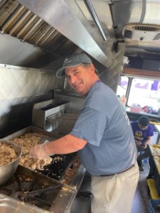 Employee cooking and smiling