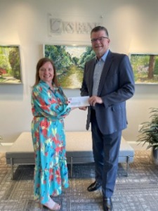 Bank CEO giving check to director of Johnston County Boys and Girls Club