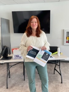 employee smiling with paperwork
