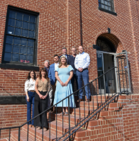 Developers of the Station Clayton project stand in front of the building with KS Bank employees.