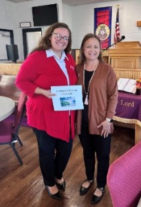 Bank employee and salvation army employee posing after financial literacy session.