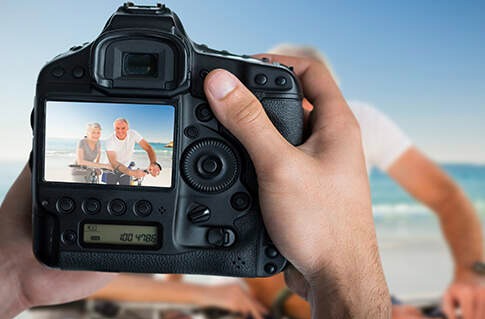 Camera screen showing mature couple biking.