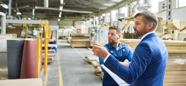 2 men in a warehouse talking