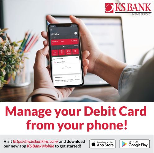 Hands holding a phone with the KS Bank mobile app on the screen