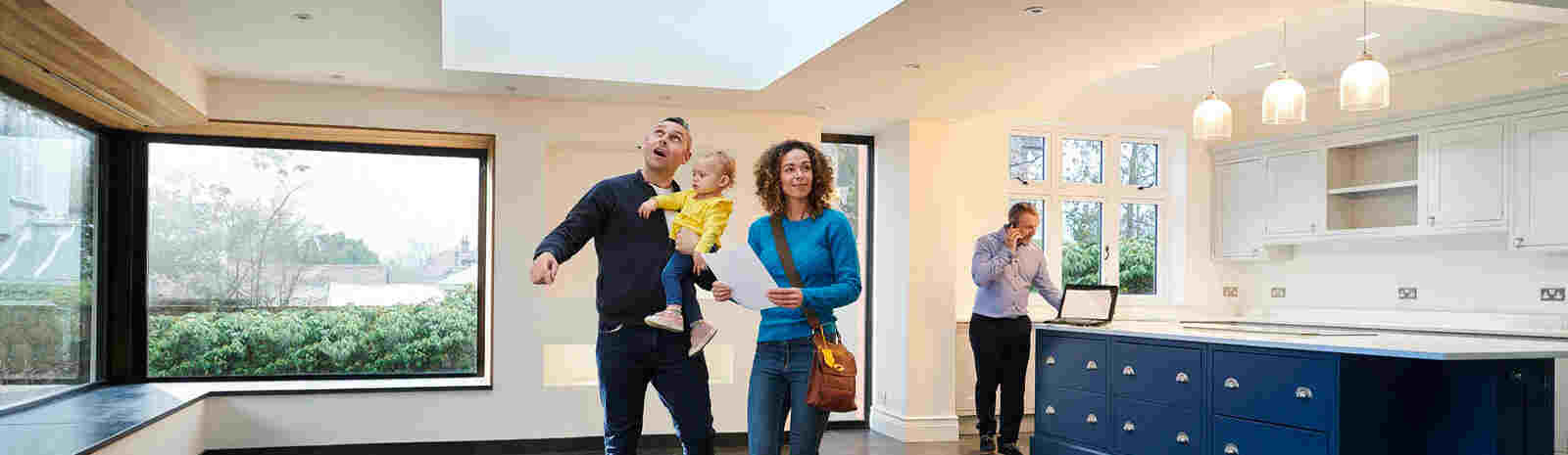 Young family walks inside new home.