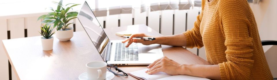 Woman's hands typing on a laptop computer